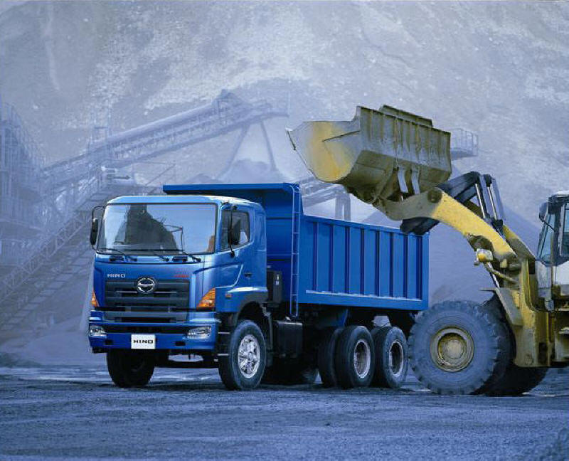 Blue Hino dump truck and front end loader at stone quarry