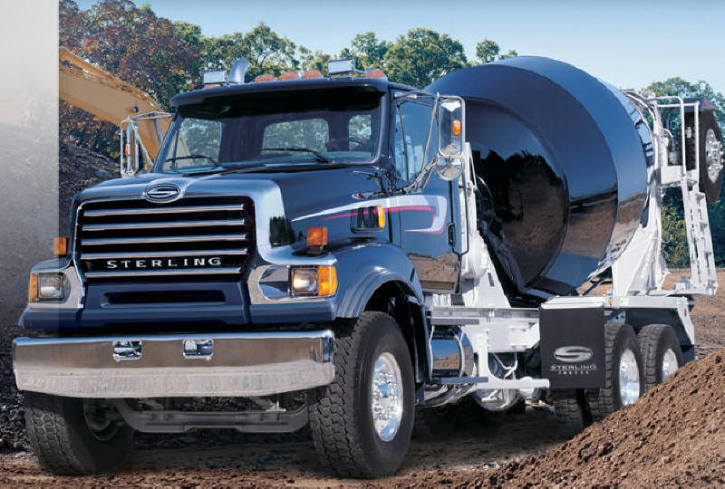 Shiny new black Sterling cement mixer Concrete Truck on the job site