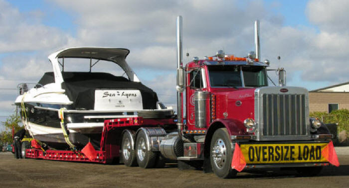 oversize load, wide and over dimentional cargo load on trombone trailer boat hauler