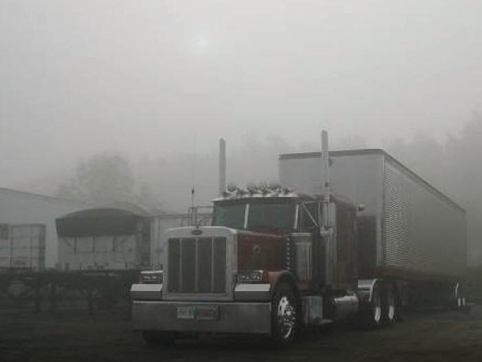 Great Dane trailer on Peterbilt  tractor early morning in fog